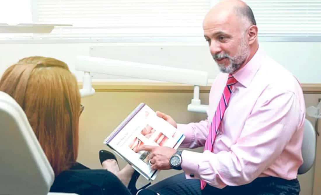 Patient smiling after dental implant restoration